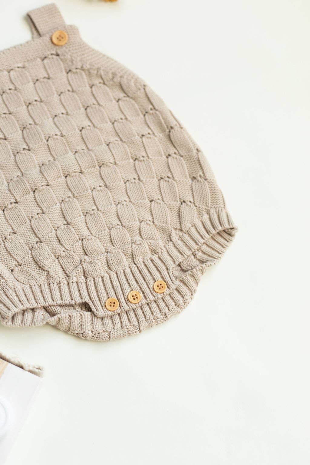 Knitted romper with buttons